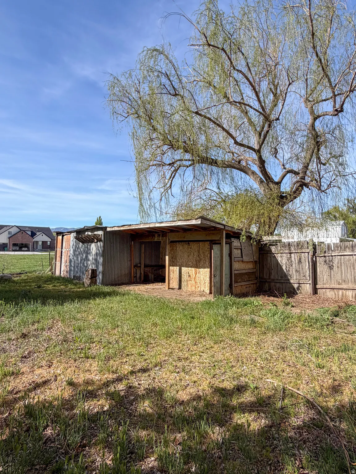 Rear view of property featuring an outbuilding