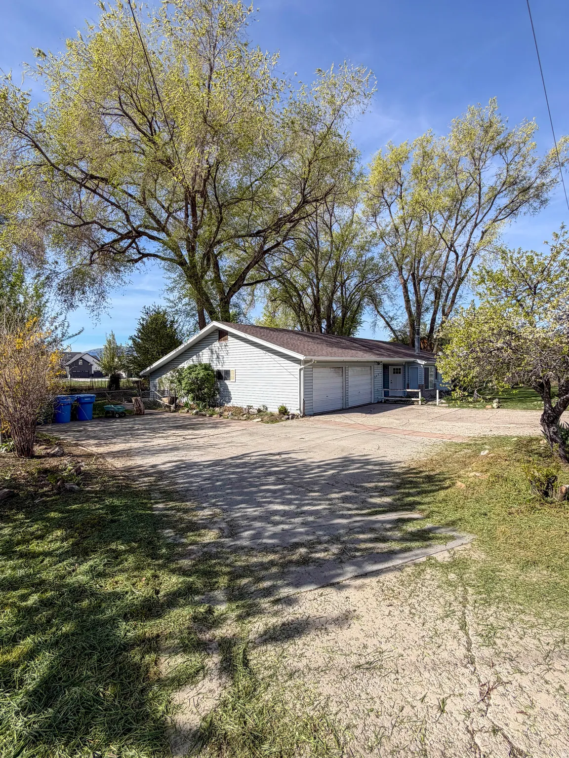 View of side of property with driveway and an attached garage