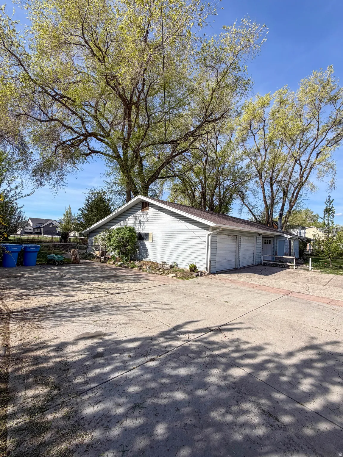 View of home's exterior with concrete driveway and an attached garage