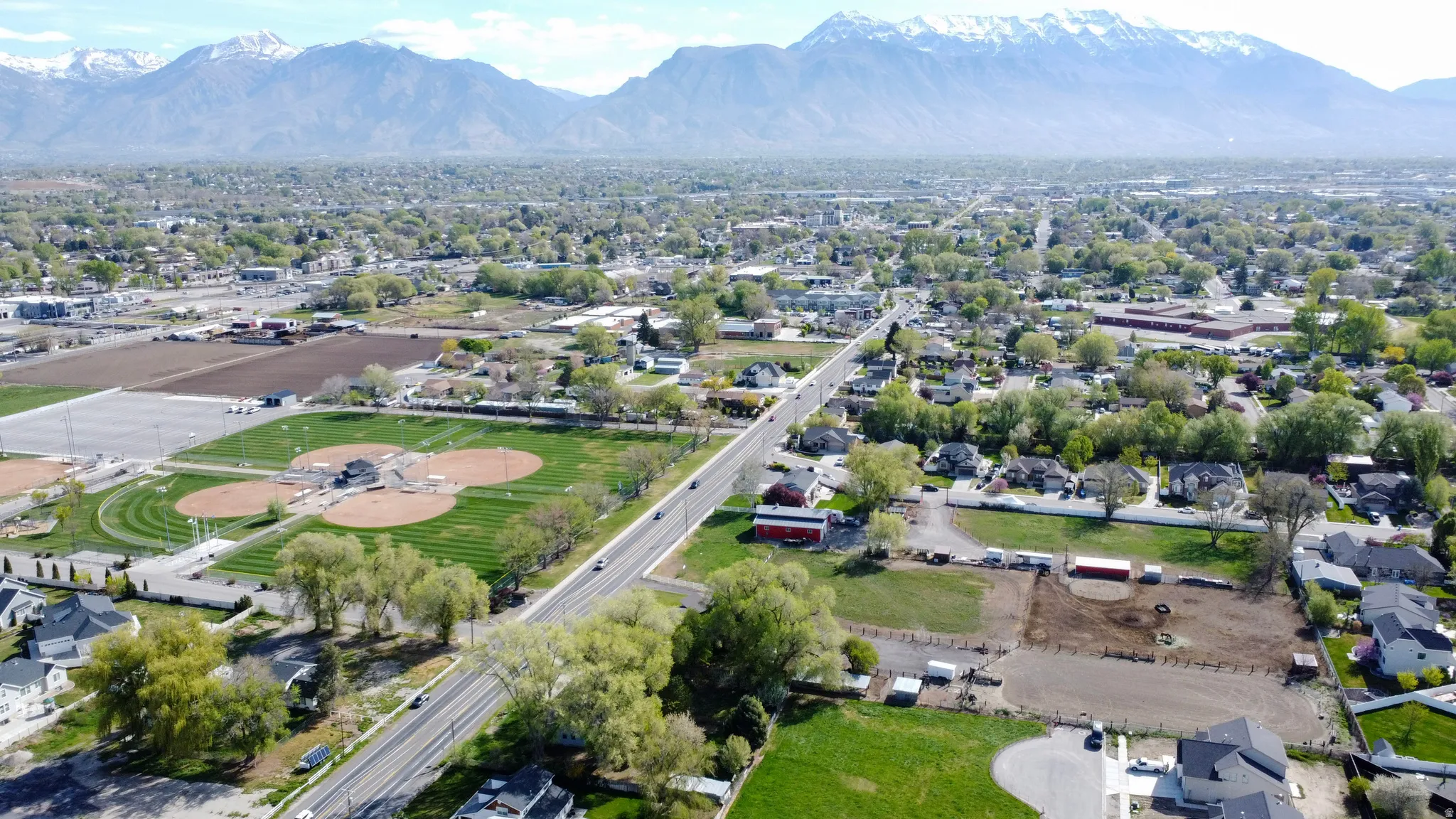 Aerial perspective of suburban area featuring a mountain backdrop