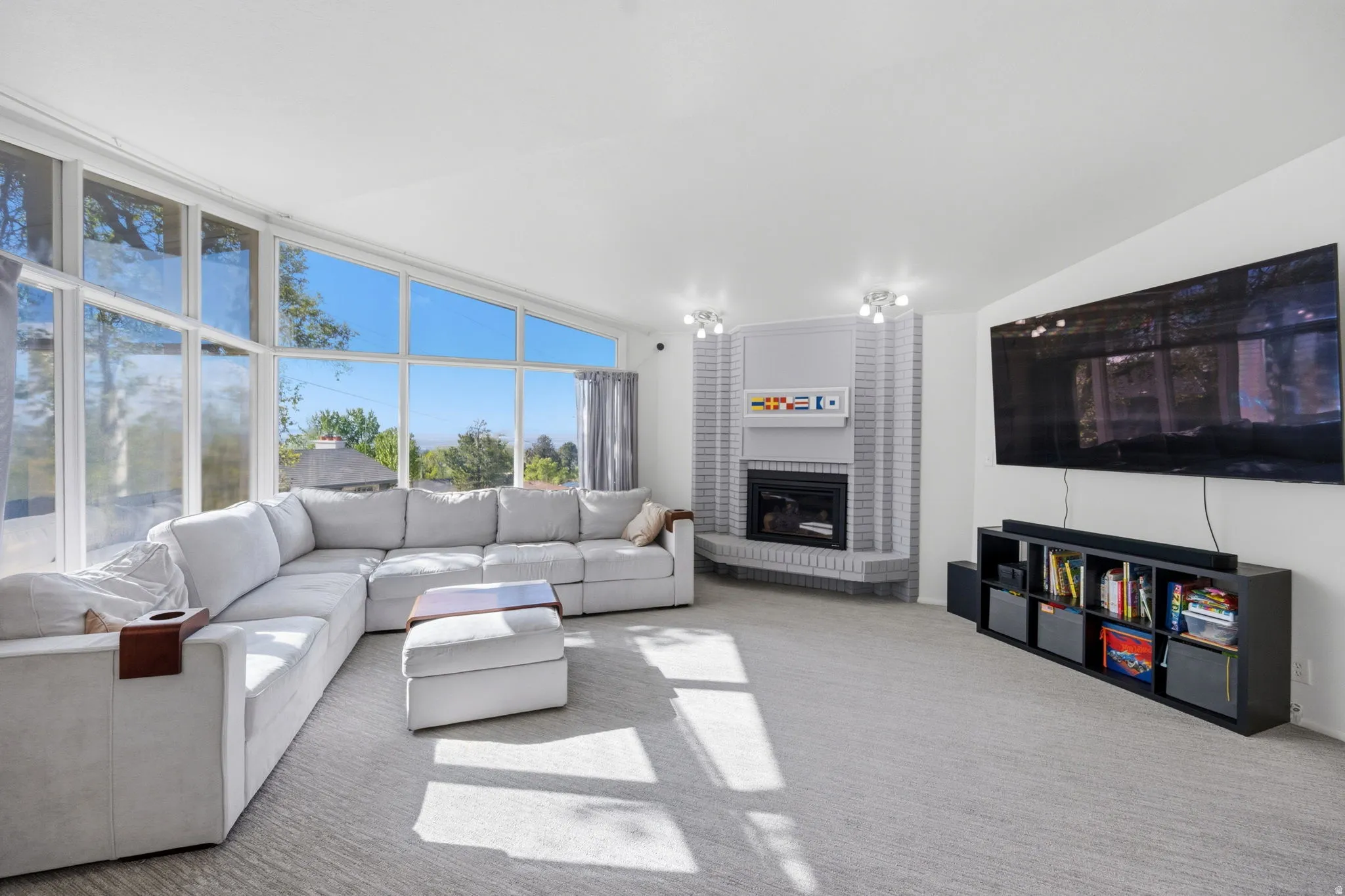 Living room with carpet flooring and a fireplace