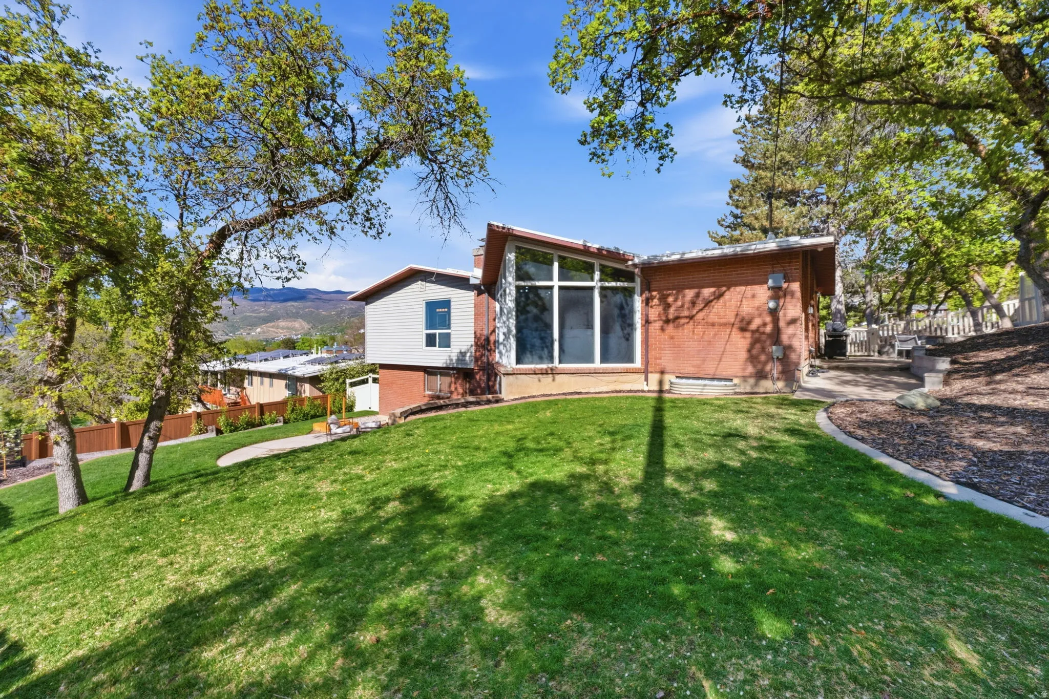 Rear view of property featuring brick siding