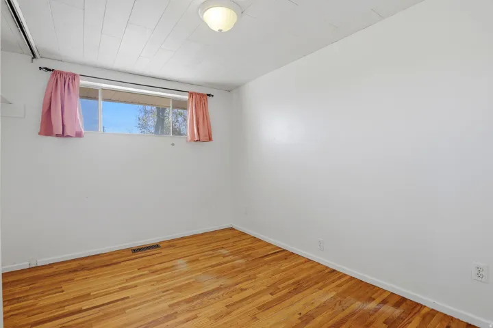 Empty room featuring light wood-type flooring and baseboards