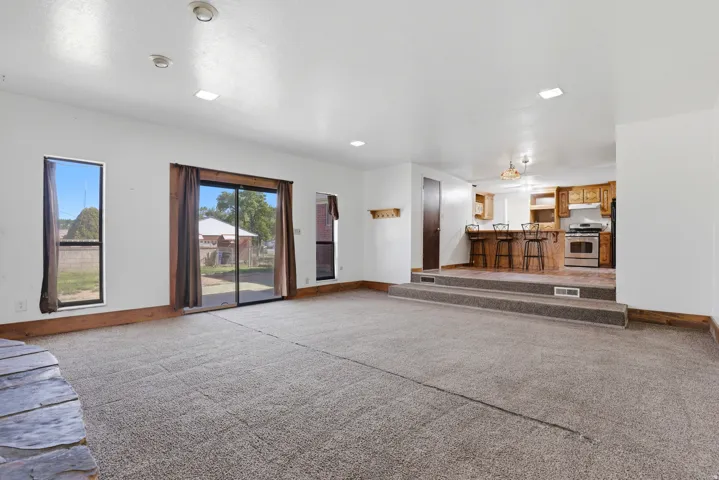 Unfurnished living room featuring carpet flooring