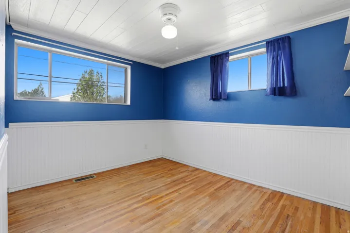 Unfurnished room with light wood-type flooring and wainscoting