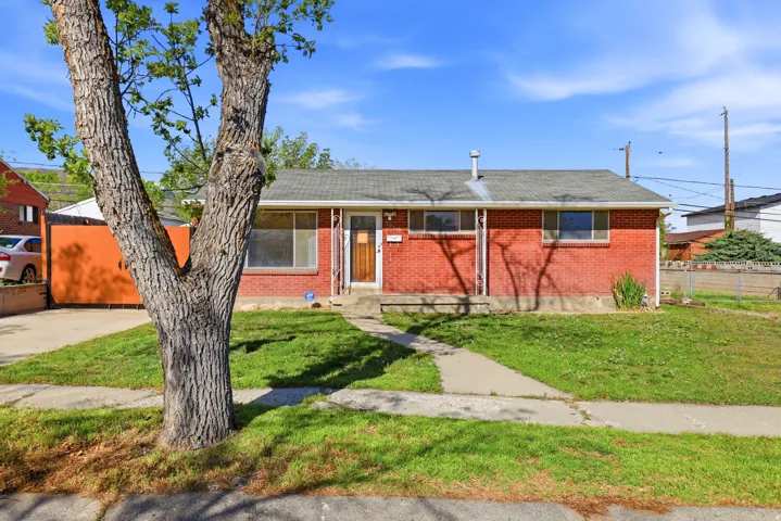 View of front of home featuring brick siding and a shingled roof