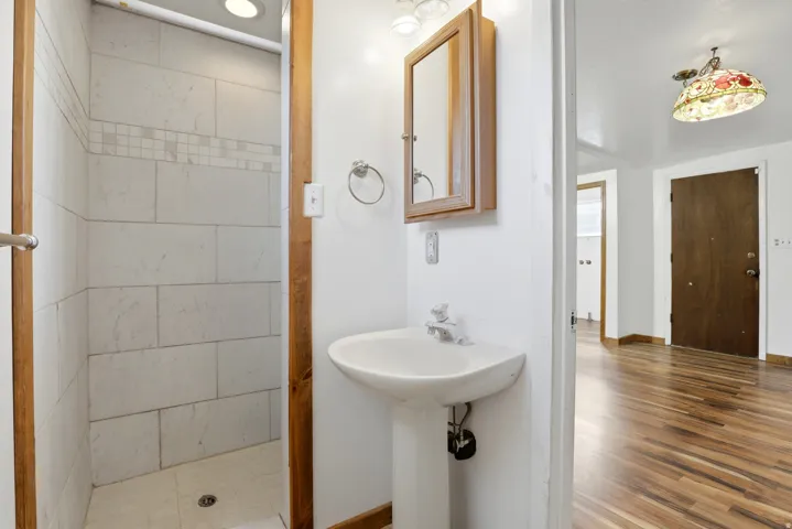 Bathroom with a stall shower and baseboards