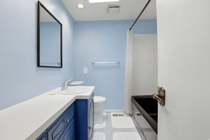Full bath featuring vanity, recessed lighting, and light tile patterned flooring