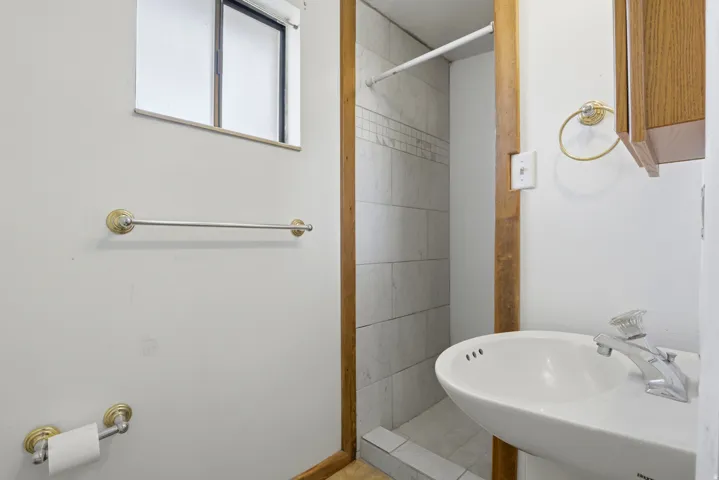 Full bathroom featuring a shower stall