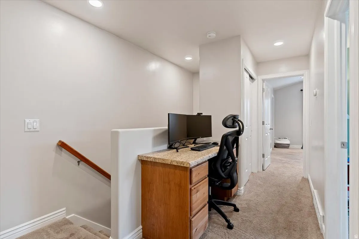 Office featuring light carpet and recessed lighting