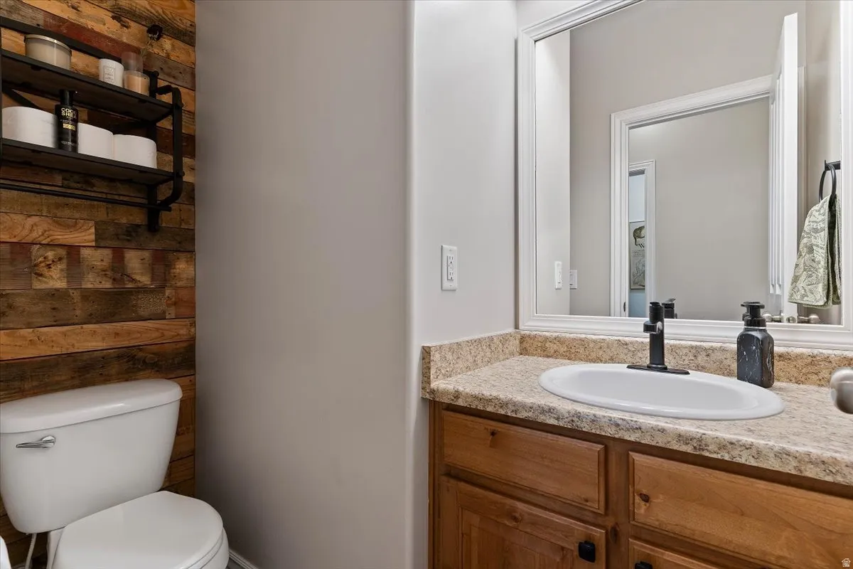 Half bathroom with toilet and vanity