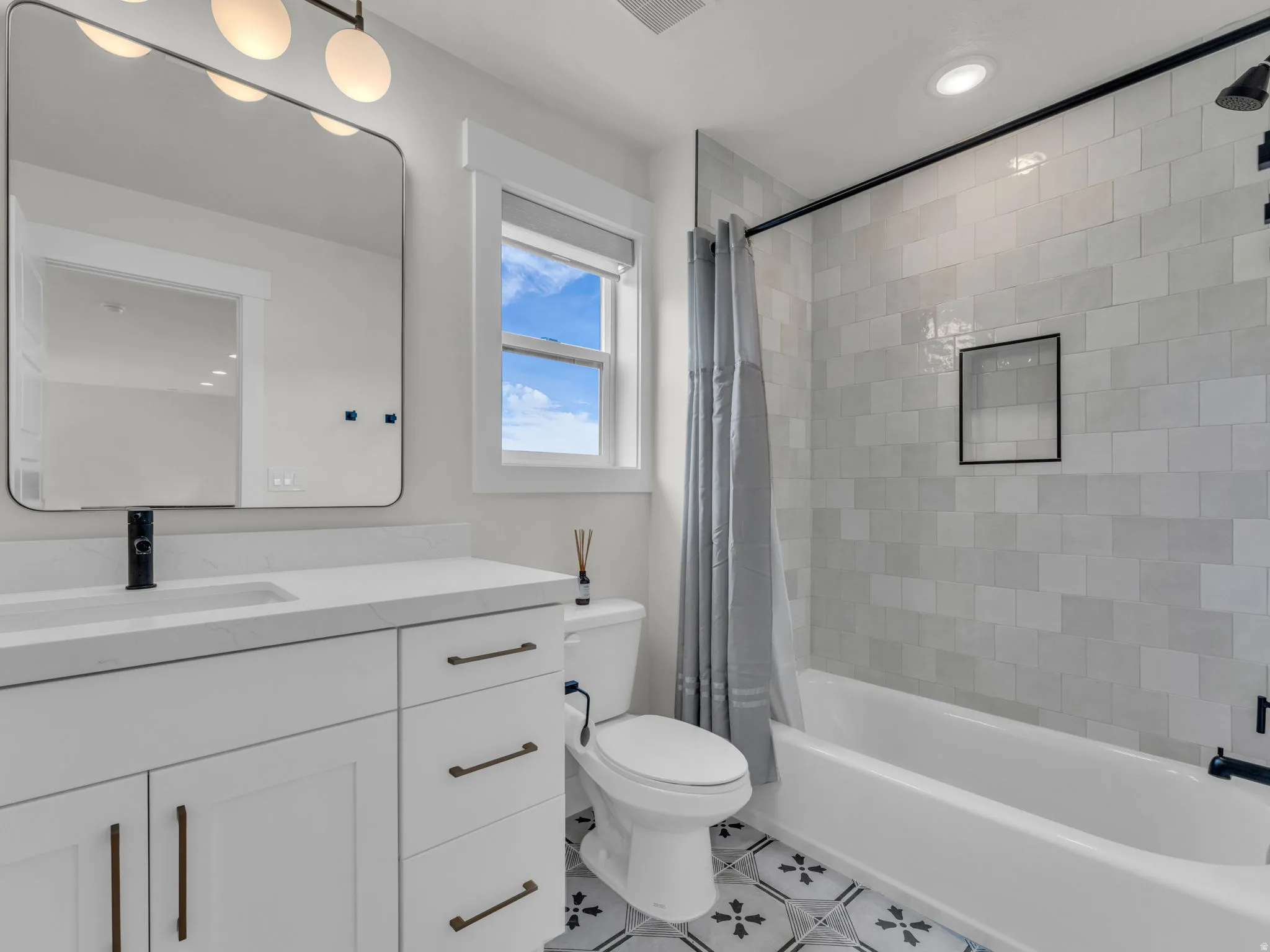 Full bathroom featuring vanity, shower / bath combo, recessed lighting, and light tile patterned flooring