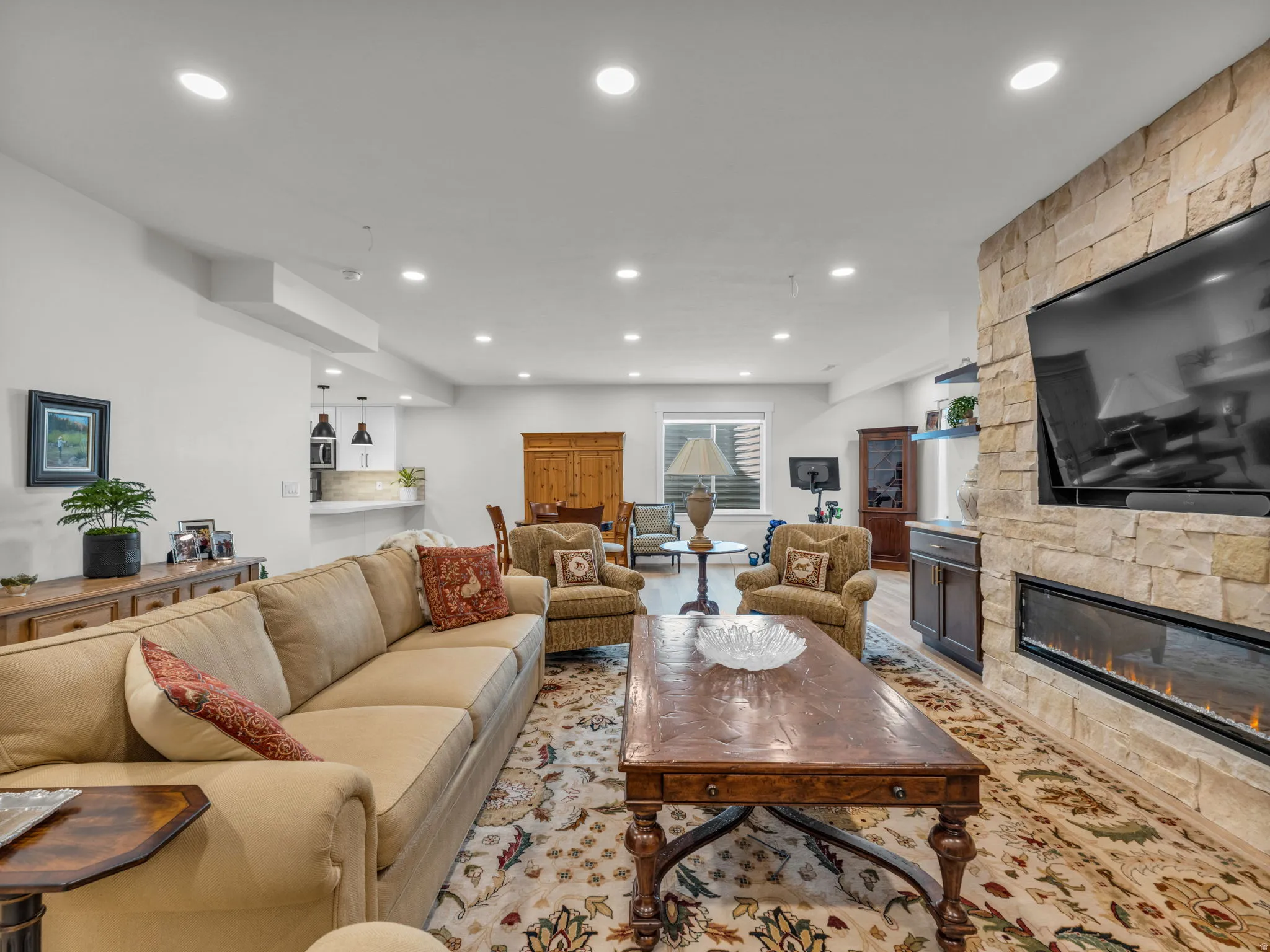 Living area with a fireplace, recessed lighting, and light wood-type flooring