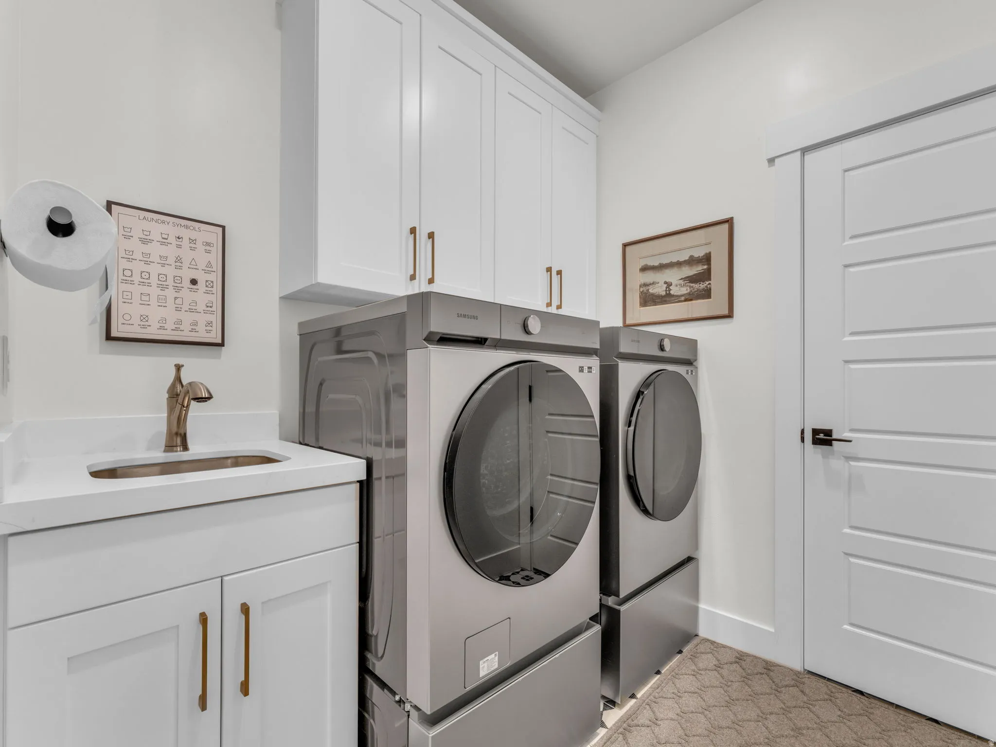 Laundry area featuring washing machine and dryer and cabinet space