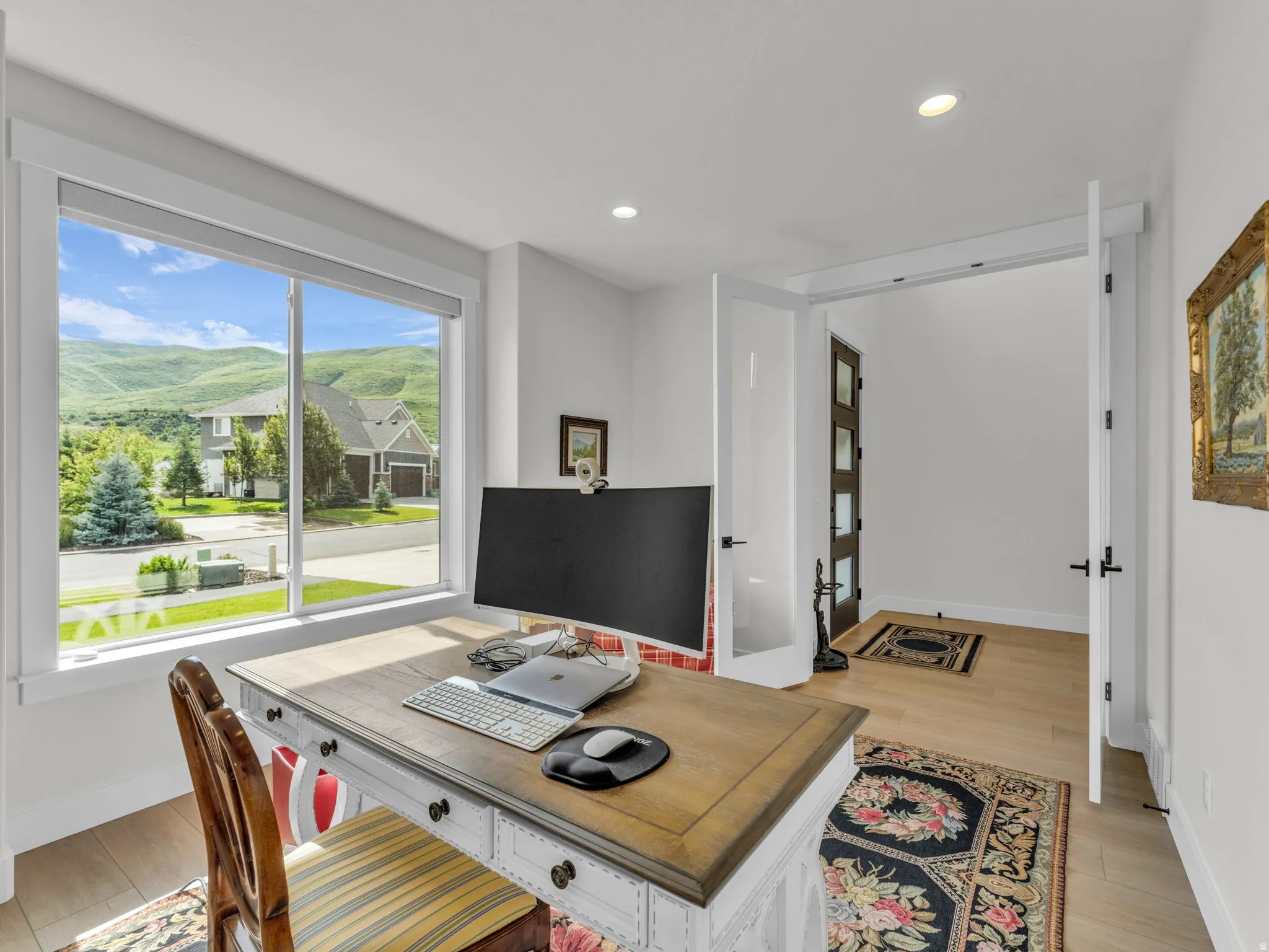 Home office featuring light wood-style floors and recessed lighting
