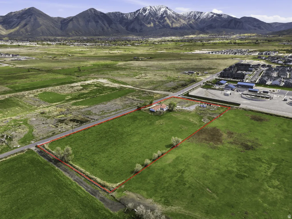 Overview of rural landscape with property parcel outlined and mountains