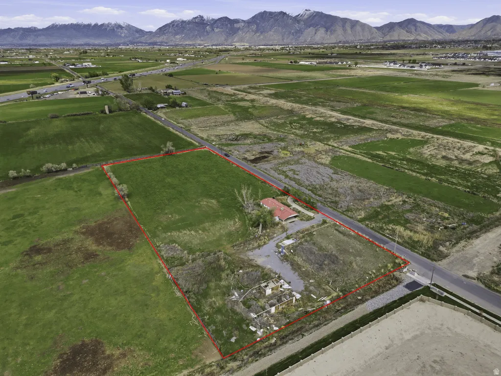 Overview of rural landscape featuring property parcel outlined, a mountain backdrop, and abundant farmland