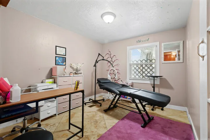Office with a textured ceiling and baseboards