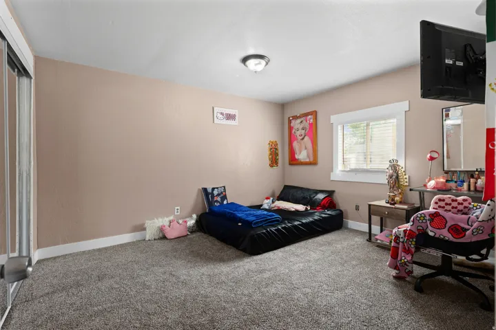 Carpeted bedroom with baseboards