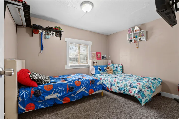 Carpeted bedroom featuring a textured ceiling