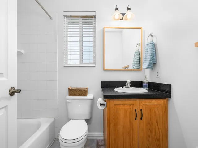 Full bath with vanity and shower / bath combination