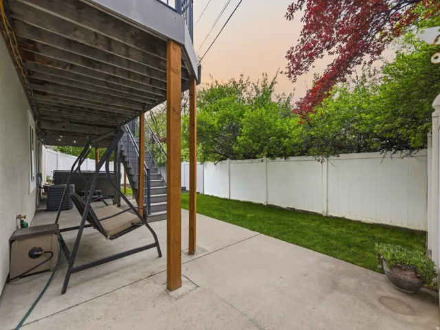 Fenced backyard with a patio area and stairway