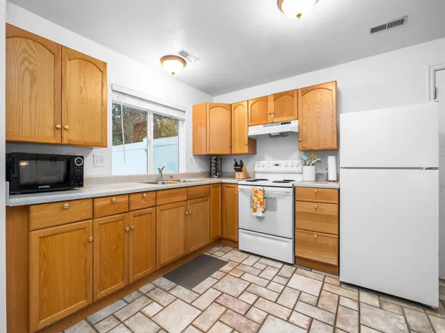 Kitchen with white appliances and light countertops