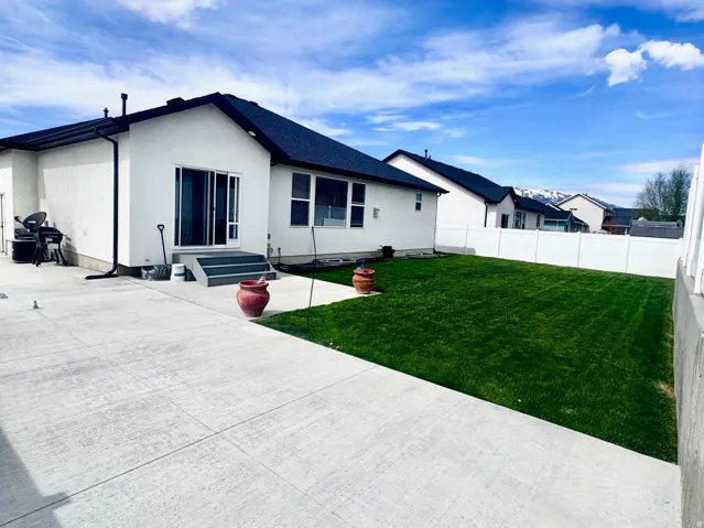 Back of house featuring a patio area, a fenced backyard, and entry steps