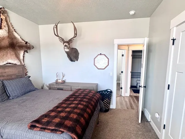 Bedroom with carpet and a textured ceiling
