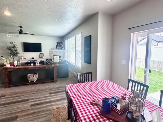 Dining space featuring recessed lighting, a textured ceiling, a ceiling fan, and wood finished floors