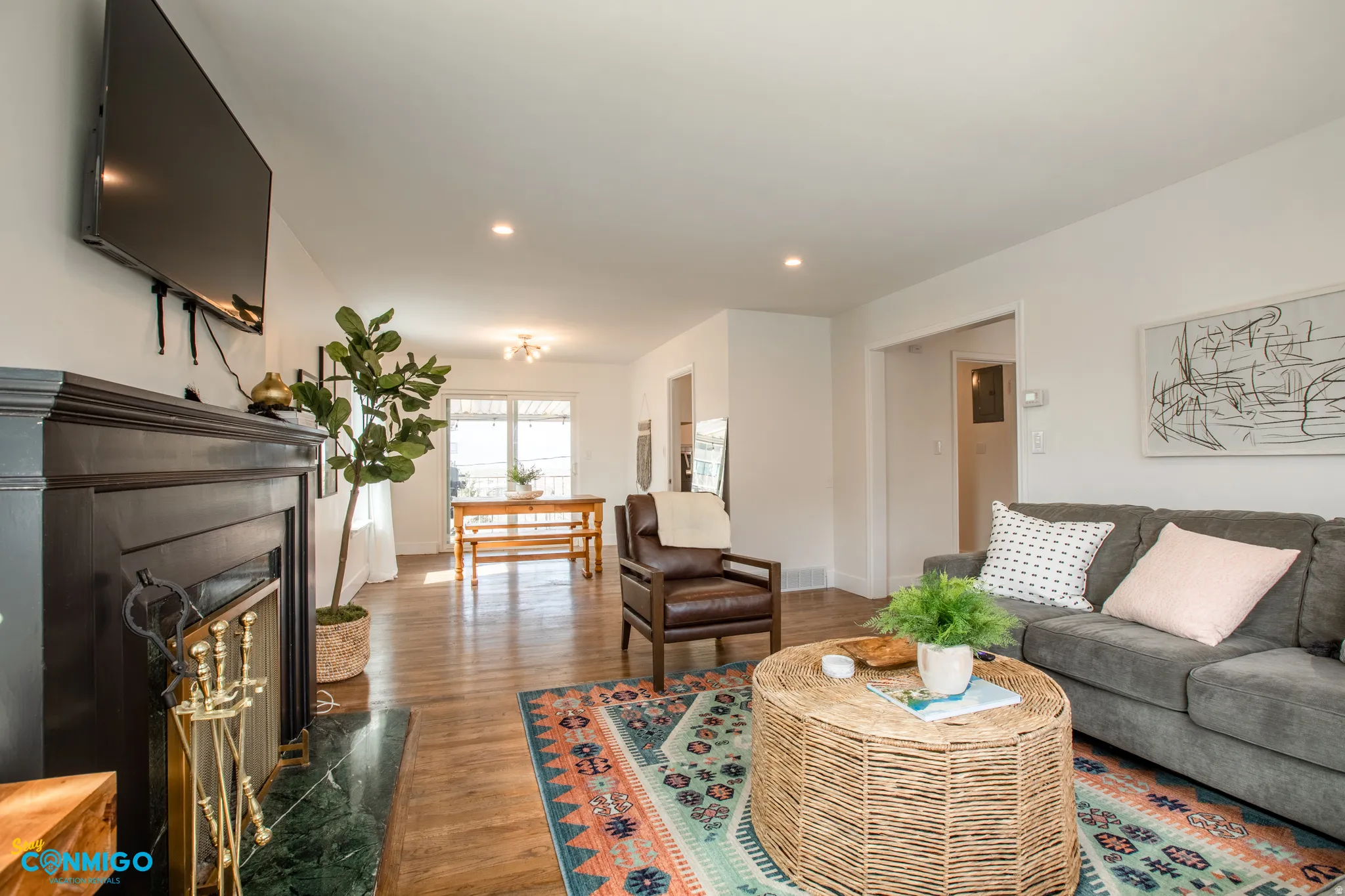Living area featuring a premium fireplace, dark wood-style flooring, and recessed lighting