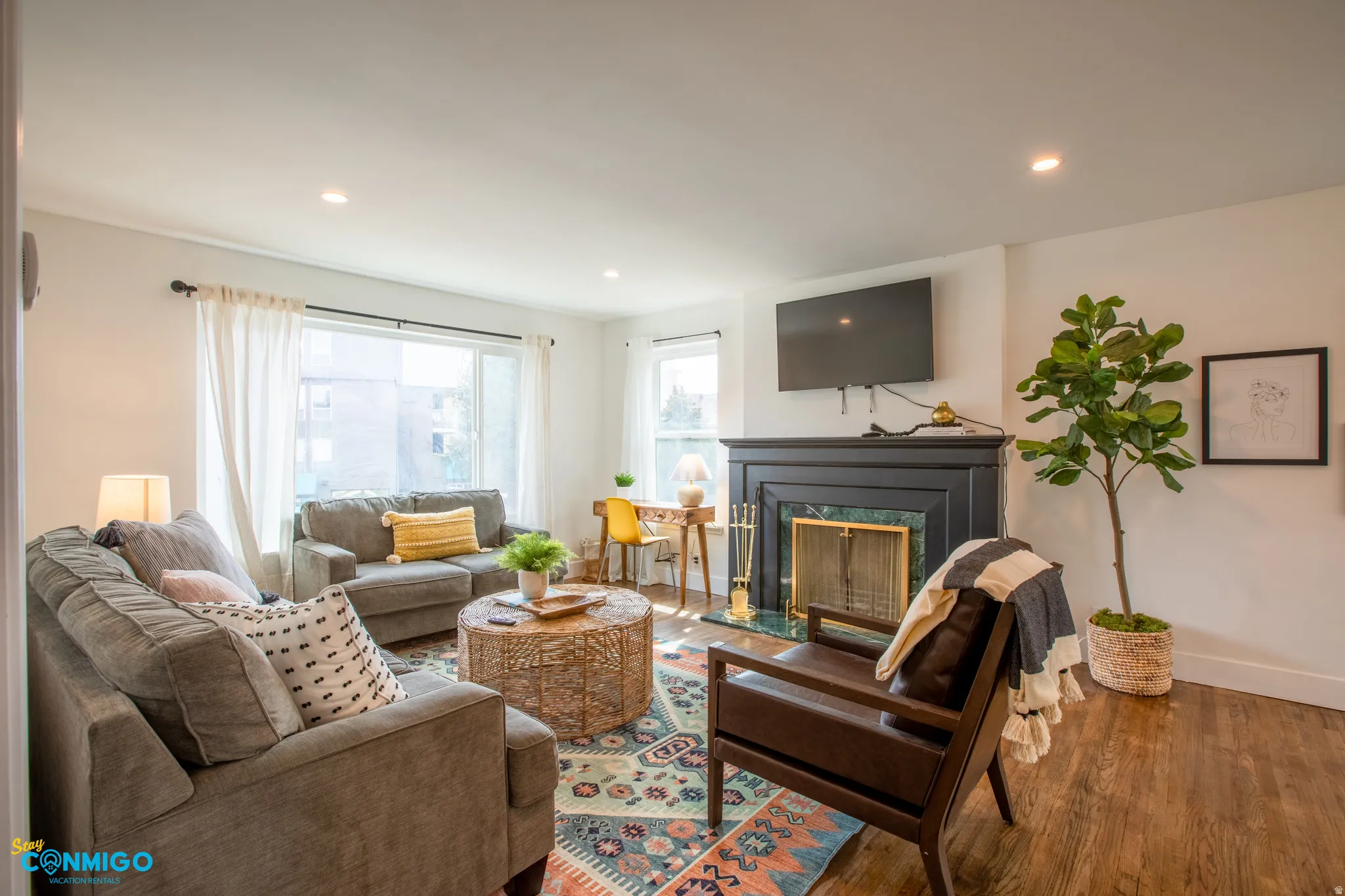 Living area featuring wood finished floors, a fireplace, and recessed lighting