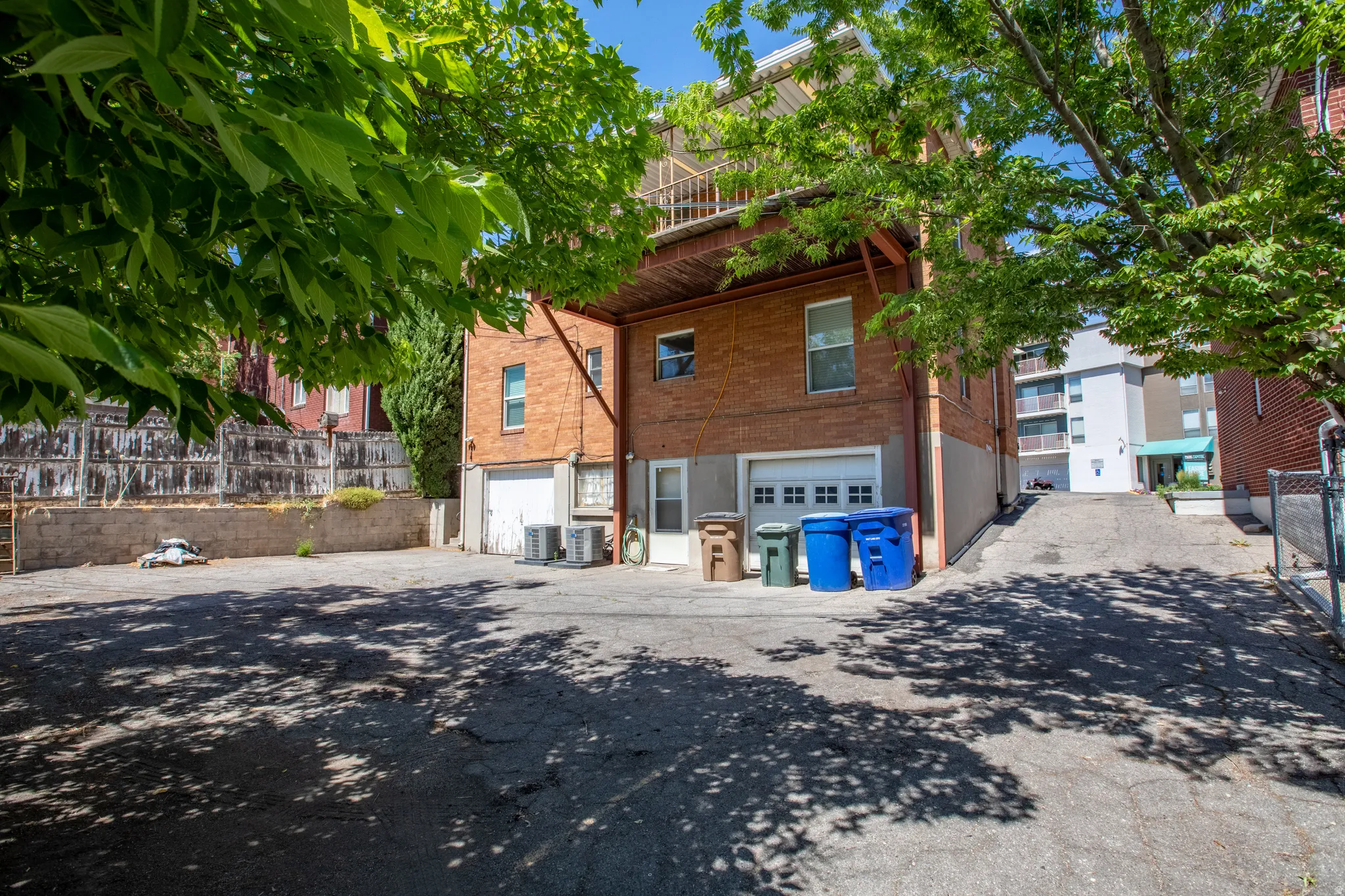 View of home's exterior featuring an attached garage, brick siding, and driveway