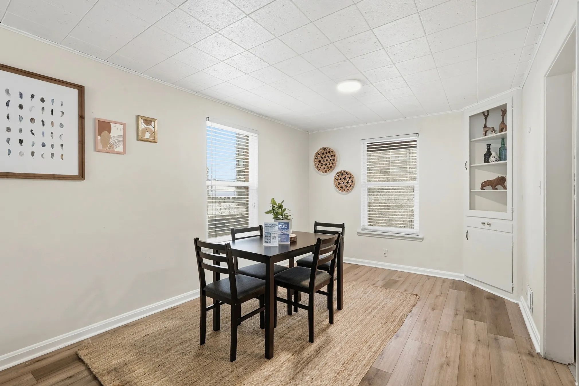 Dining space featuring light wood-style floors and built in shelves