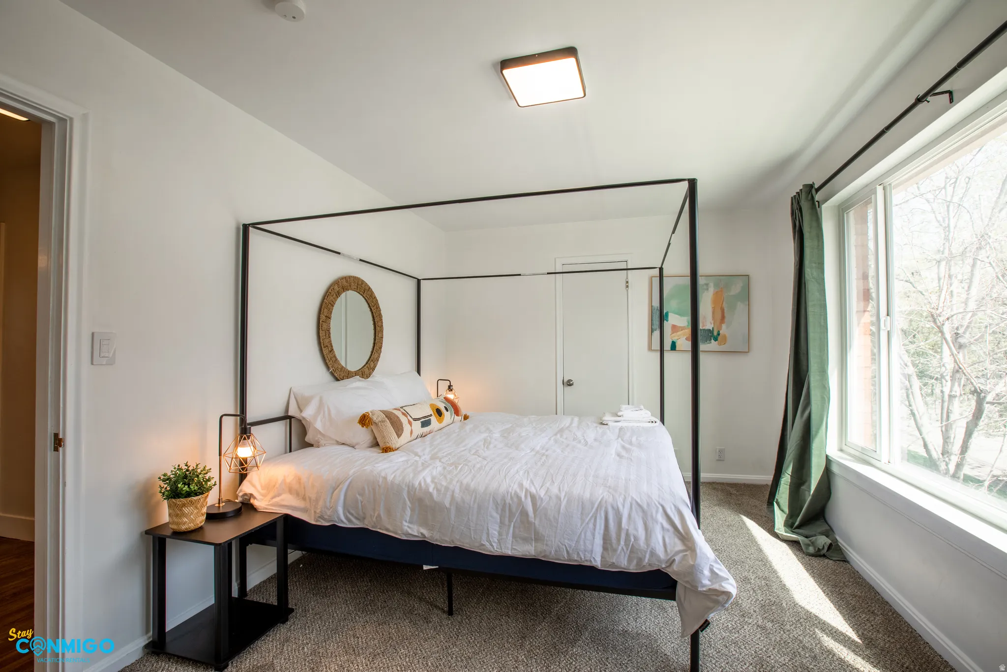 Bedroom featuring carpet and baseboards