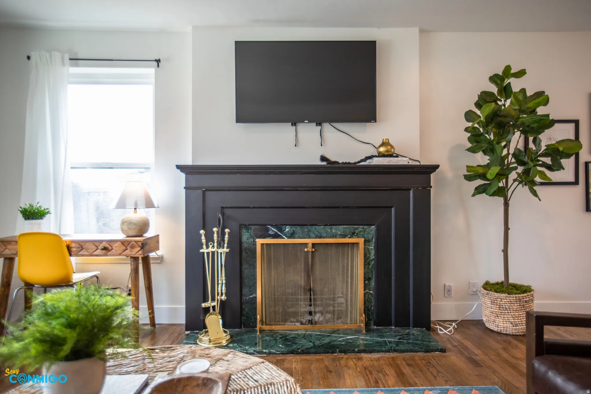 Detailed view of wood finished floors and a high end fireplace