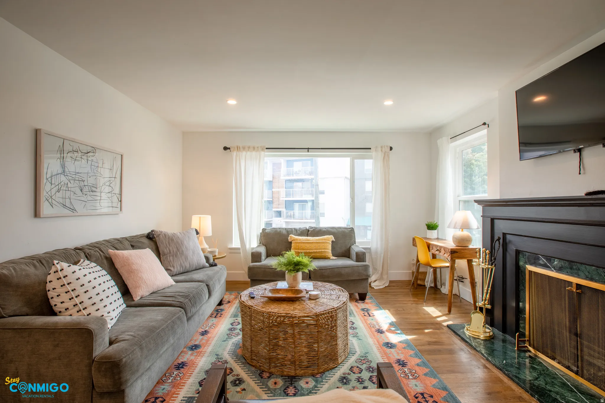Living area with wood finished floors, a premium fireplace, and recessed lighting