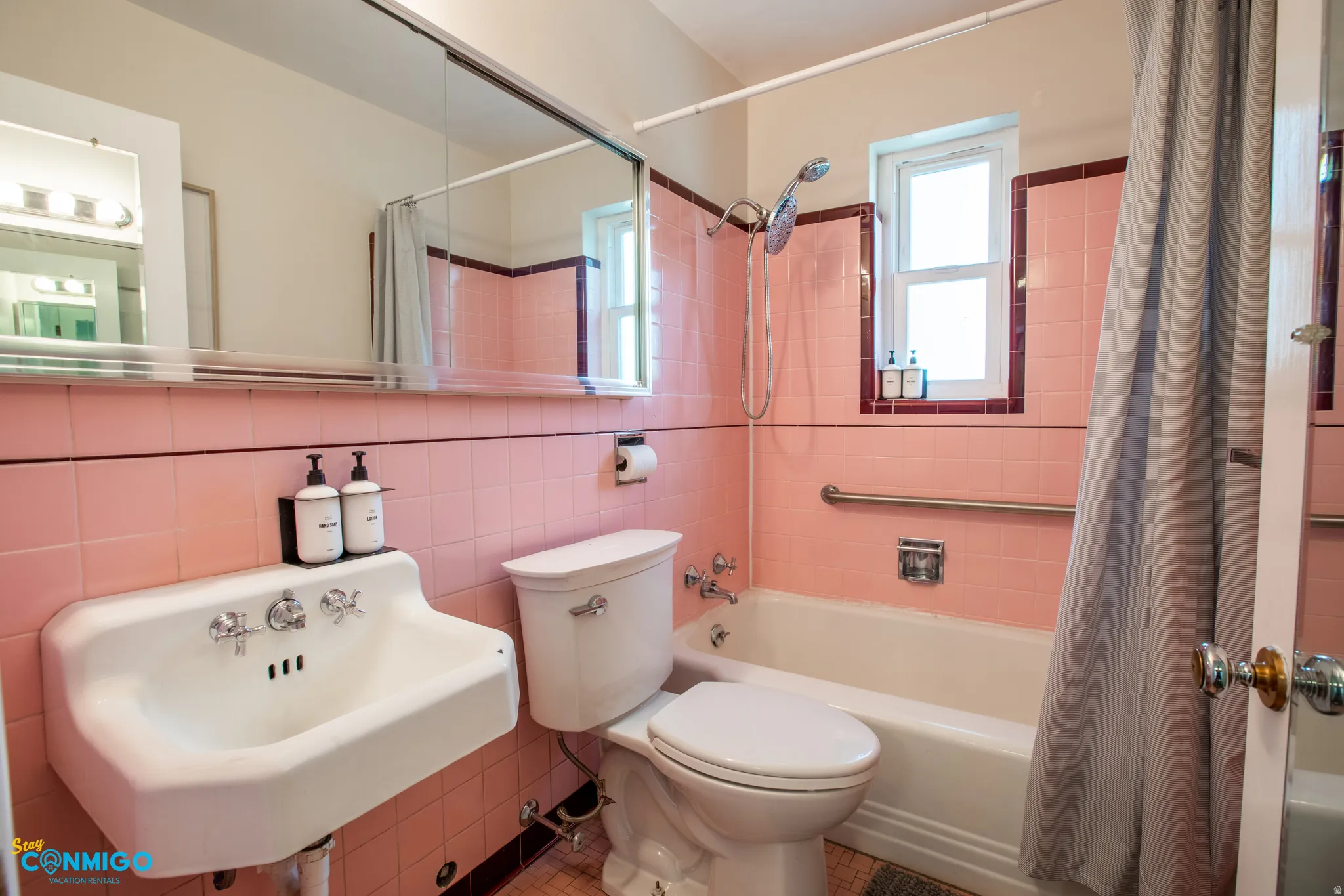 Full bath featuring tile walls and shower / tub combo