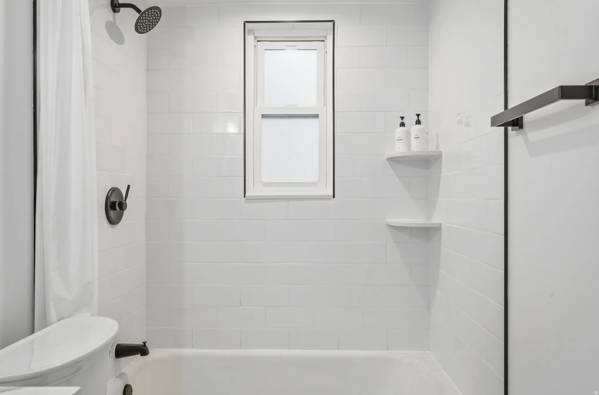 Bathroom featuring shower / tub combo with curtain and toilet