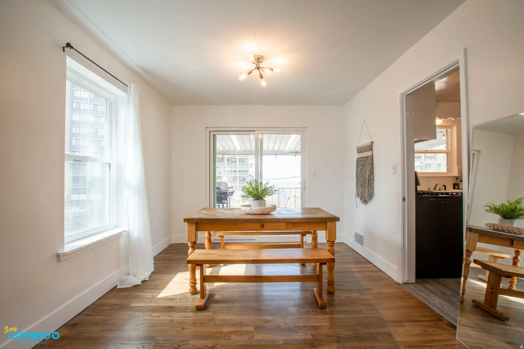 Dining space with dark wood-style floors and baseboards