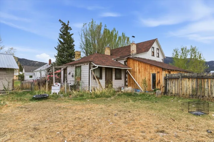 Rear view of property featuring a chimney