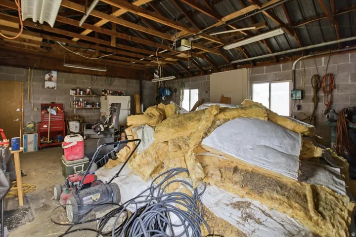 Garage featuring concrete block wall