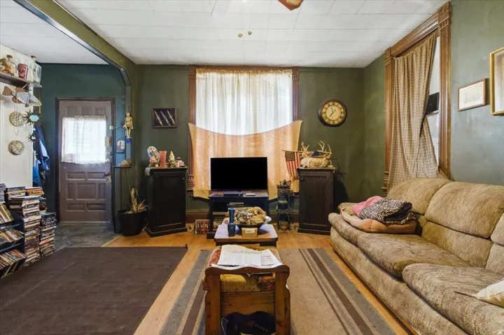 Living room with light wood-style floors and ceiling fan
