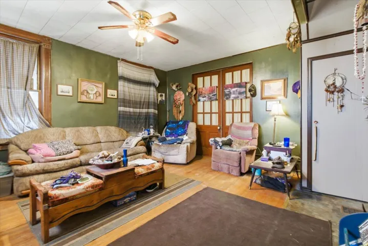 Living room with a ceiling fan and light wood-style floors