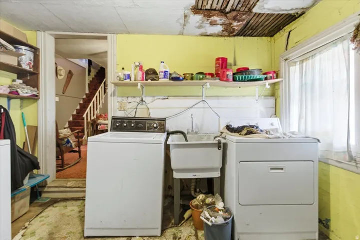 Laundry room with independent washer and dryer and a sink