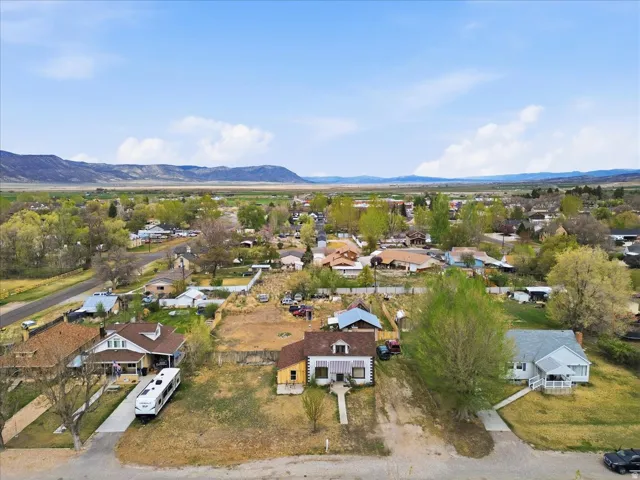 Aerial overview of property's location with nearby suburban area and a mountain backdrop