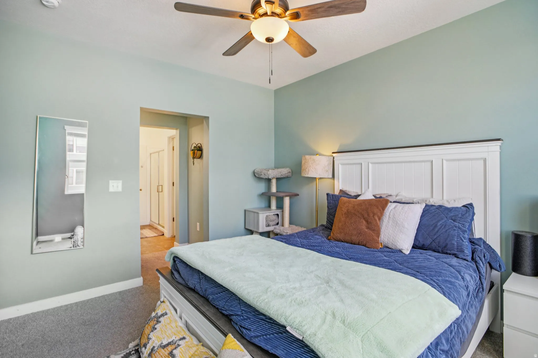 Carpeted bedroom with baseboards and ceiling fan