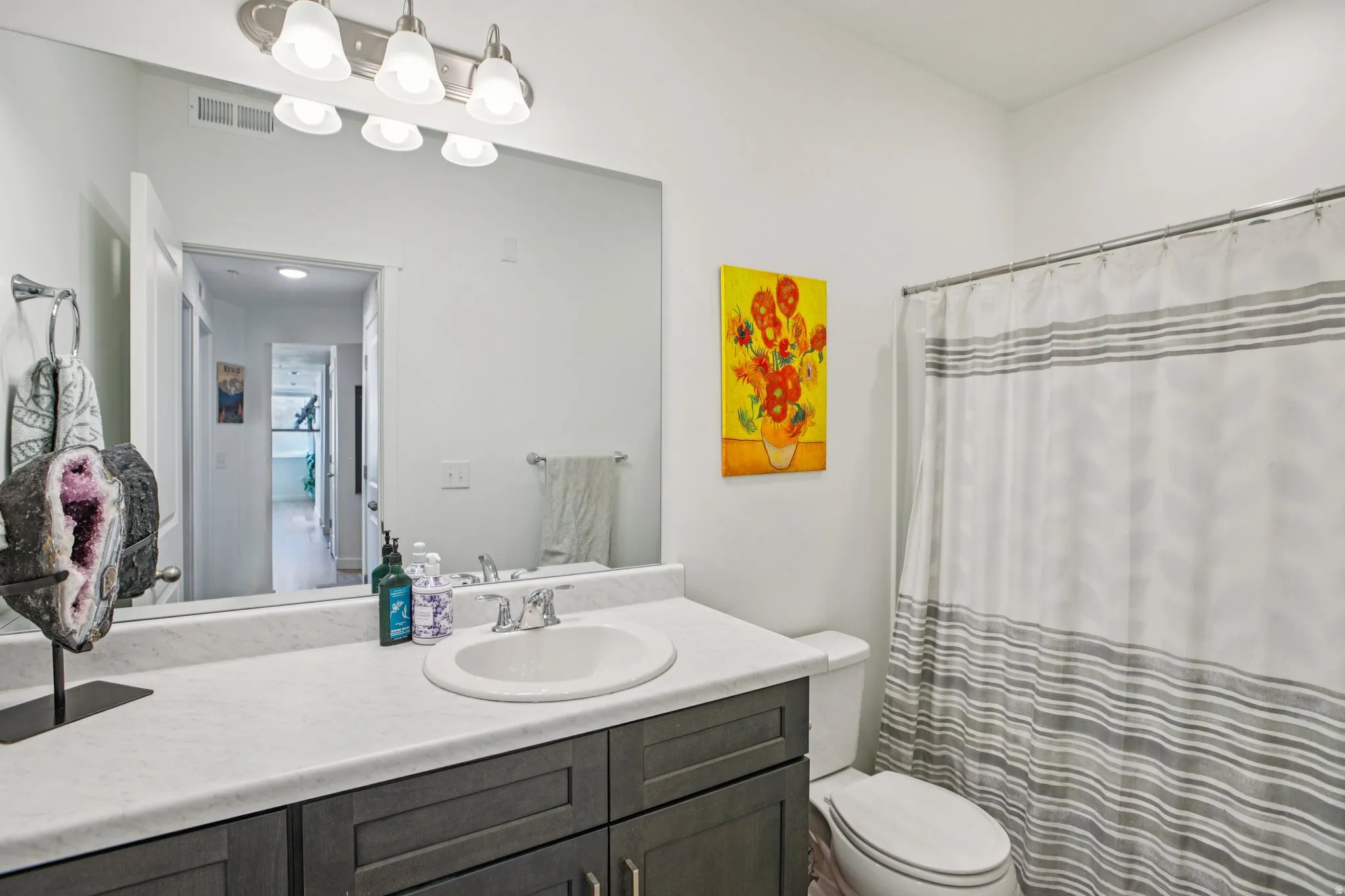 Bathroom with vanity and curtained shower