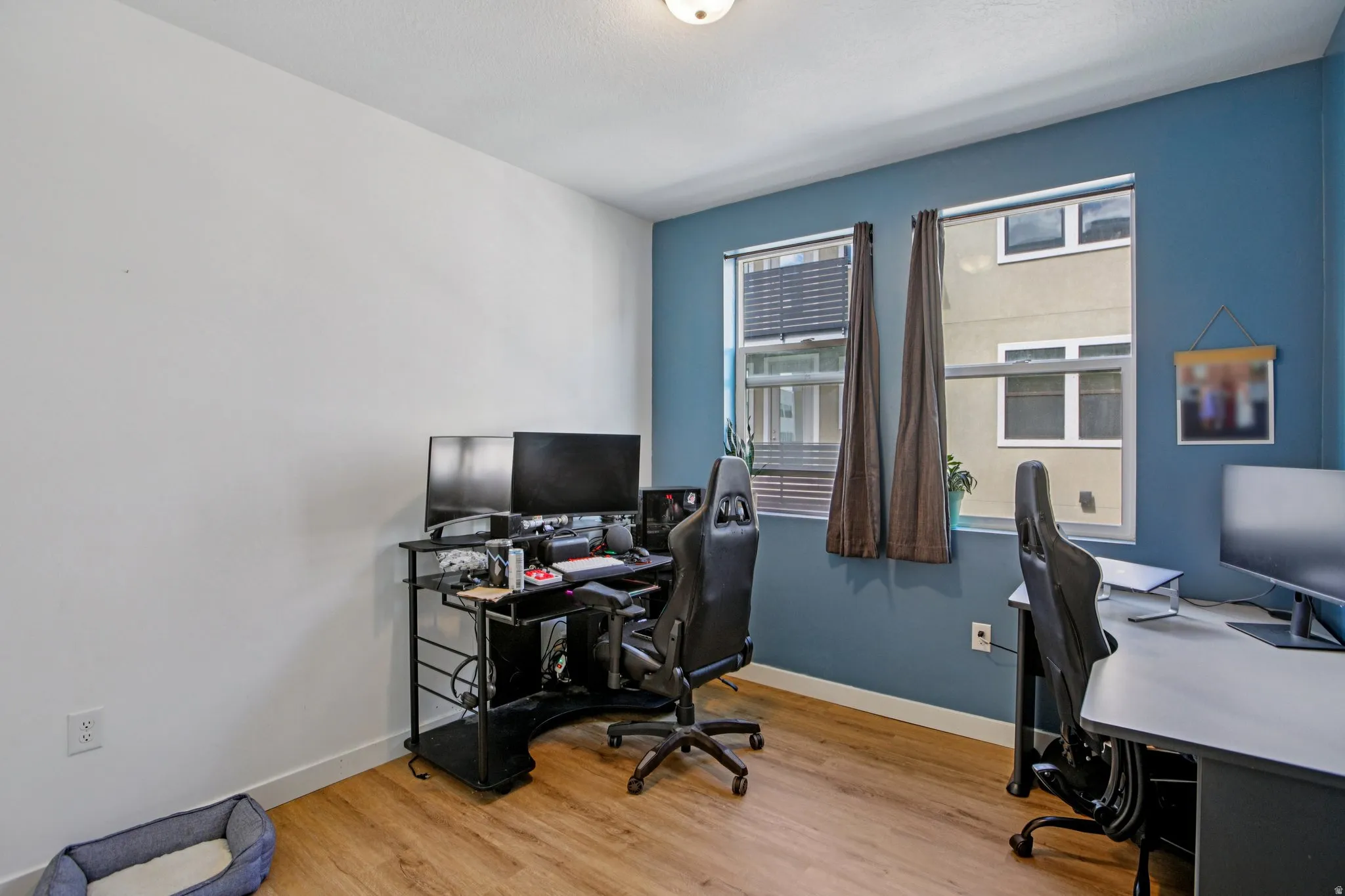 Home office featuring light wood-style flooring and baseboards
