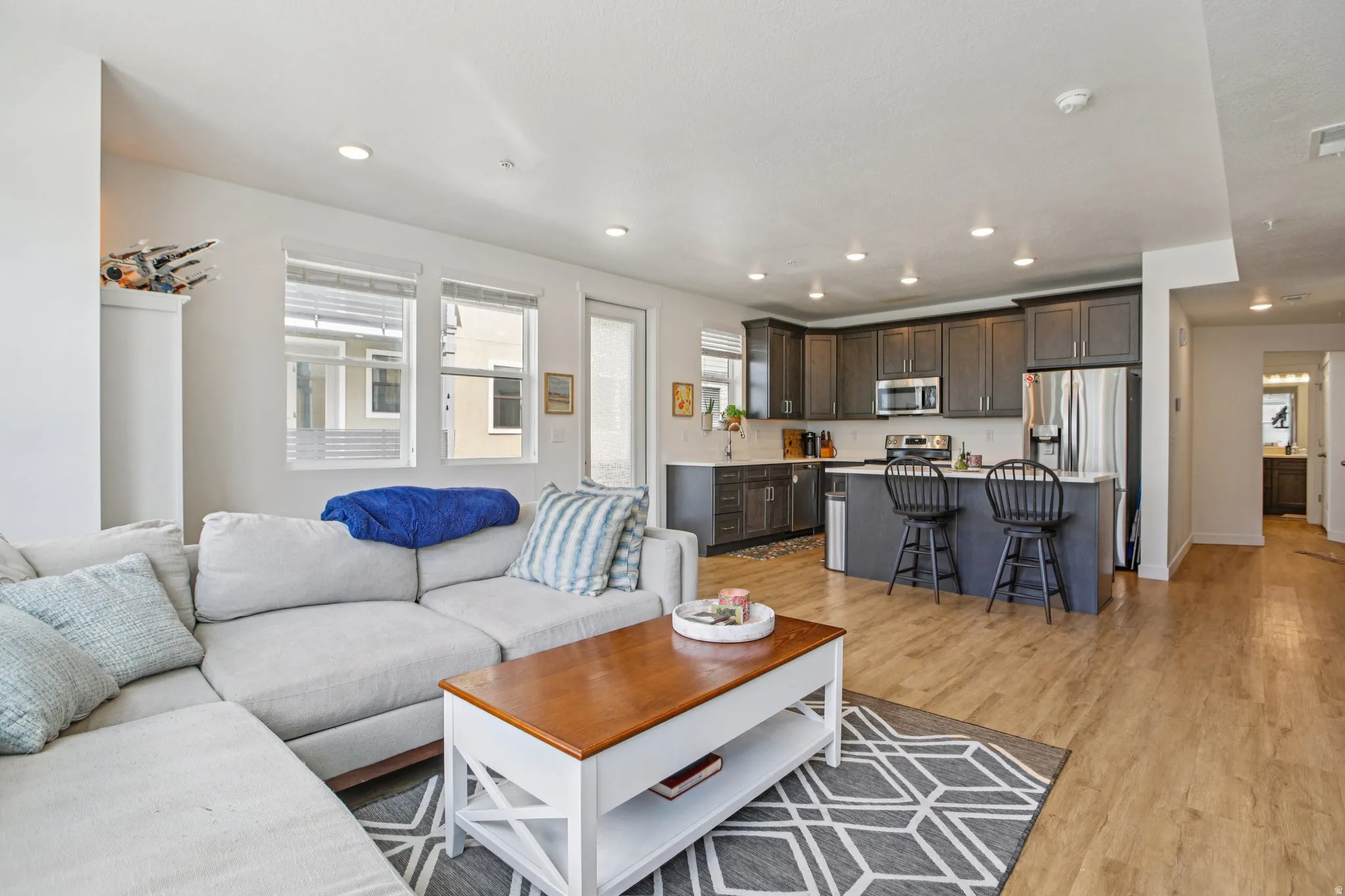 Living room featuring light wood-type flooring and recessed lighting